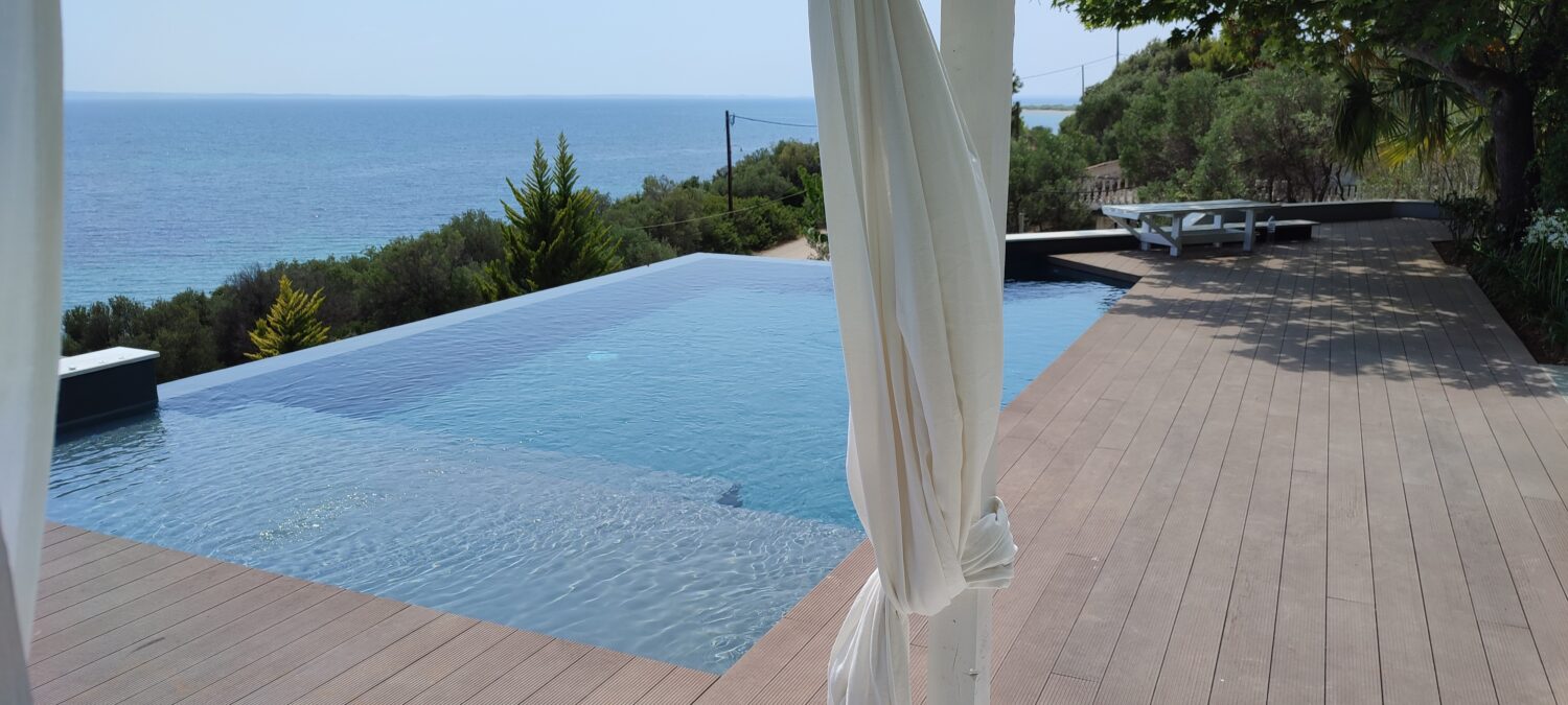 corner pool waterfall with deck